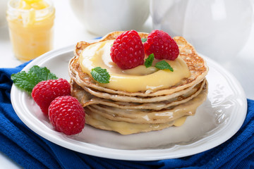 Delicious pancakes with lime curd and raspberries.