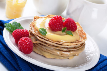 Delicious pancakes with lime curd and raspberries.