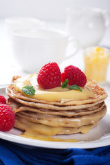 Delicious pancakes with lime curd and raspberries.