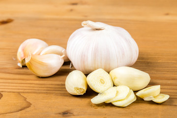 Peeled and sliced garlic cloves with garlic bulb and cloves