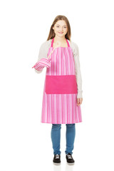 Happy teen woman wearing kitchen apron.