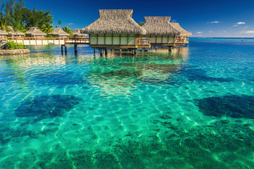 Villas in the lagoon with steps into shallow water with coral