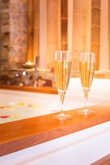 Two glasses of champagne near jacuzzi