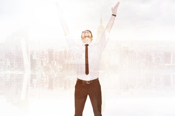 Smiling businessman cheering with his hands up