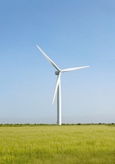 Fototapeta premium Wind turbine on the beautiful autumn meadow