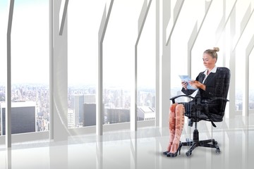 A businesswoman sitting on chair with her tablet