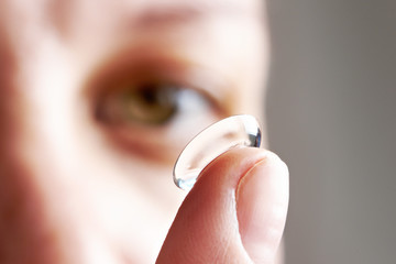 Young woman with contact lens