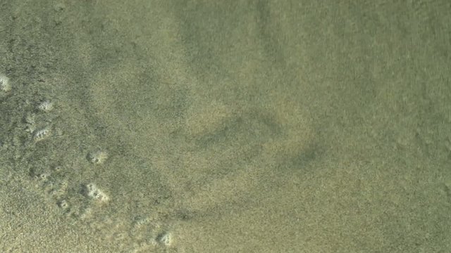 drawing a heart in the sand and wash by ocean wave