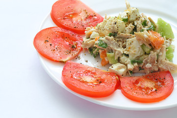 appetizing chicken salad decorated with tomatoes