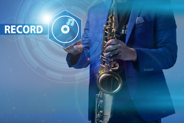 Music concept. musician with a saxophone icon clicks on the virt