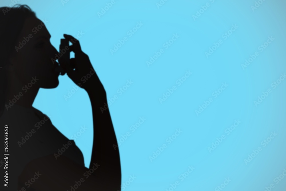 Poster Composite image of asthmatic brunette using her inhaler 