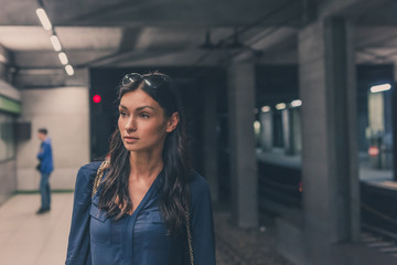 Beautiful girl posing in a metro station