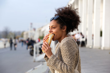 Young woman eating junk food