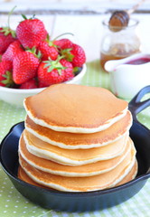 pancakes with fresh strawberry  in a small pan
