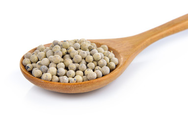 peppercorn in the wooden spoon on white background