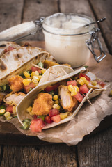 Tortilla bread with fried chicken meat and vegetables