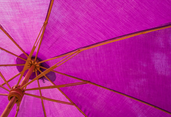 Structure under a purple umbrella.