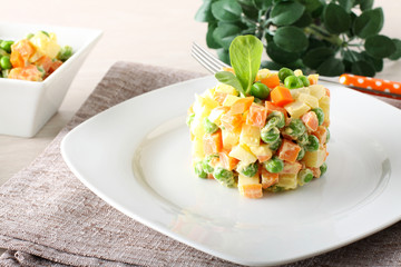 Russian salad with peas, carrots, potatoes and mayonnaise