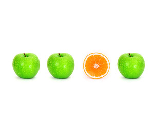sliced orange place  among green apple or different concept