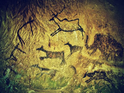 Abstract art in sandstone cave. Black carbon paint of hunting 