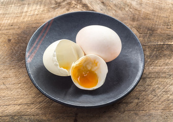 broken white eggshell on a black ceramic plate