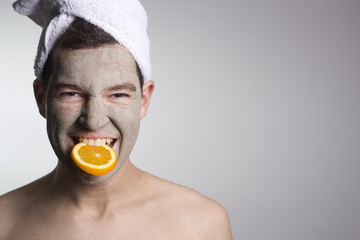 man with a mud mask on this face