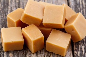 Tasty toffees on wooden background.