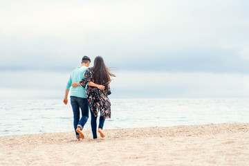 Young couple taking a walk on beach.