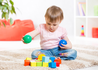child toddler playing wooden toys at home
