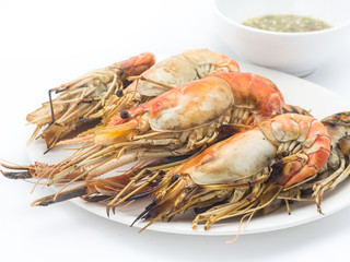 Grilled shrimps on the white plate in white background.