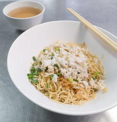 Noodle with crab in white bowl.