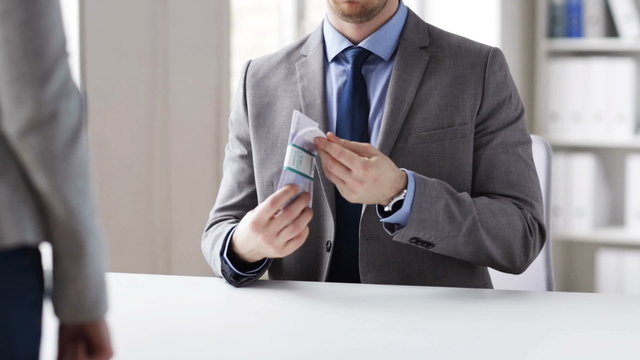 close up of businessman taking money bribe