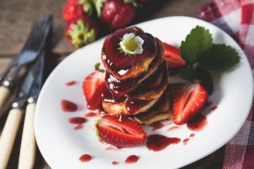 Pancakes with jam and strawberries