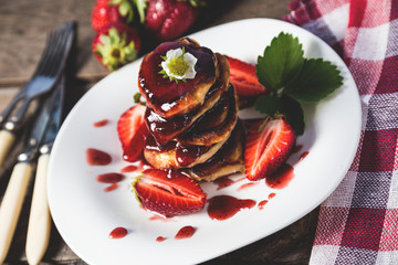 Pancakes with jam and strawberries