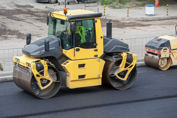 Fototapeta na wymiar Large road-roller paving a road. Road construction