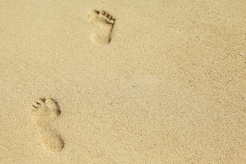 Fototapeta na wymiar two feet prints on the sand