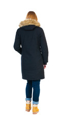 Back view of going  woman in parka.