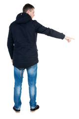 Fototapeta premium Back view of pointing young men in parka. .