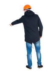 Naklejka premium Back view of pointing young men in parka and helmet.