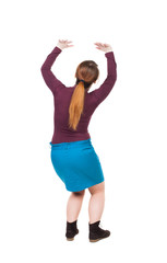 back view of woman  protects hands from what is falling from abo