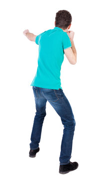 back view of skinny guy funny fights waving his arms and legs.
