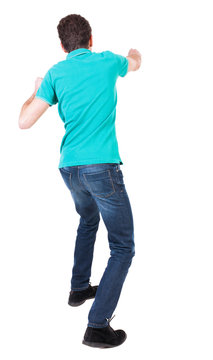 back view of skinny guy funny fights waving his arms and legs.