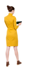 back view of standing young beautiful  girl with tablet computer