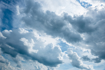 Bright blue sky background with white clouds