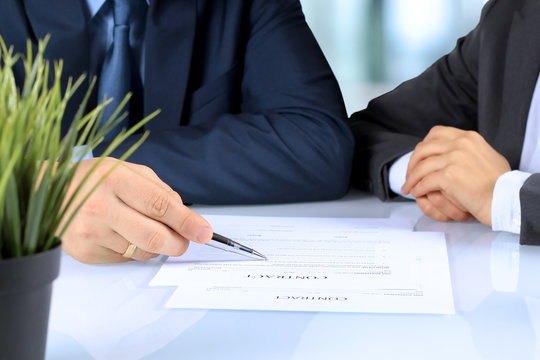 Two business partners signing a document