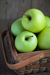 Ripe green apples (Golden Delicious) in a basket 