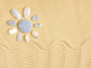Stones arranged like a sun on the beach