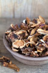 Mixed dried mushrooms (Porcini) in a bowl on the wooden table