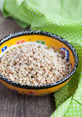 Green buckwheat sprouts in a yellow bowl, close up