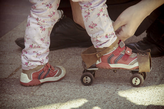 Old roller skates for infant girl. Old photo film styled picture